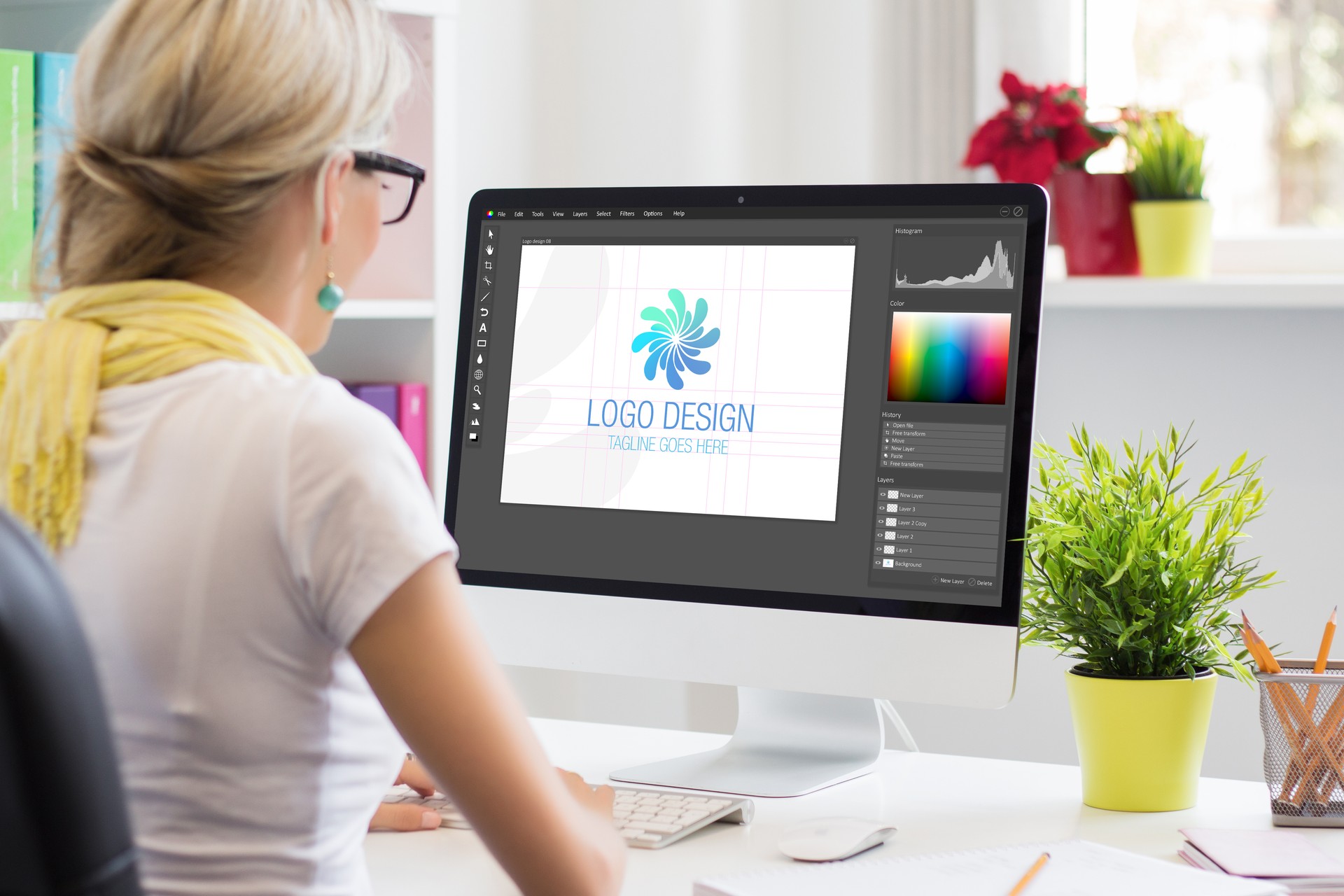 Graphic designer creating company's logo on desktop computer